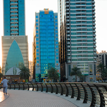Waterfront skyline buildings in Sharjah showcasing residential and commercial real estate developments in UAE