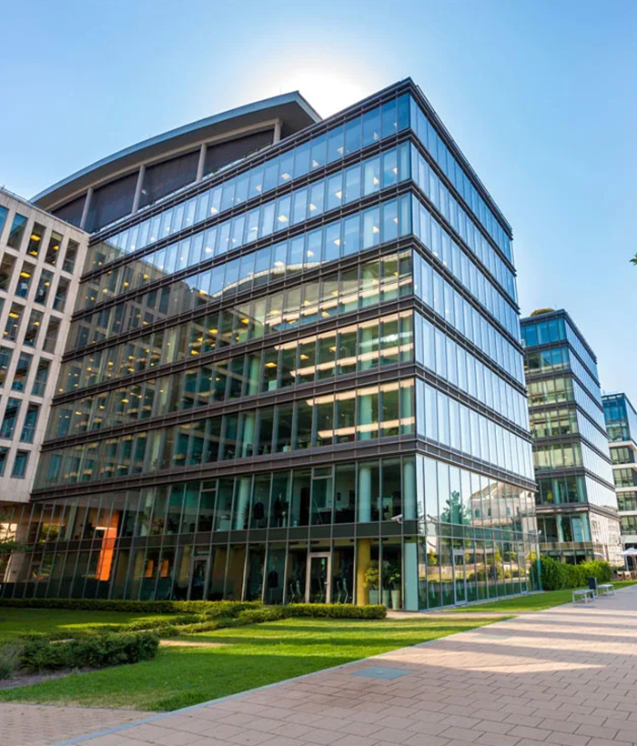 Modern glass facade office building in UAE commercial district used for property management and asset performance case study